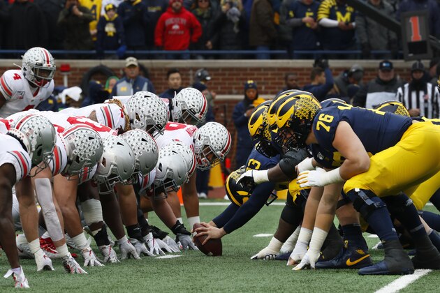 Ohio State and Michigan players play at the line of scrimmage in the first half of an NCAA college football game in Ann Arbor, Mich., Saturday, Nov. 30, 2019. (AP Photo/Paul Sancya)