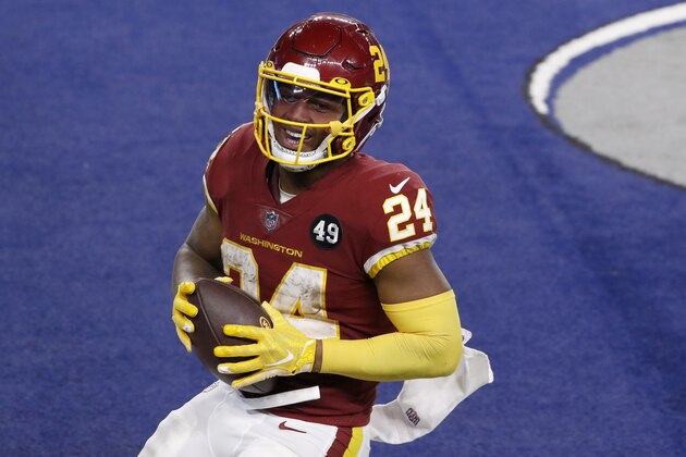 Washington Football Team's Antonio Gibson smiles after his touchdown run in the second half of an NFL football game against the Dallas Cowboys in Arlington, Texas, Thursday, Nov. 26, 2020. (AP Photo/Roger Steinman)