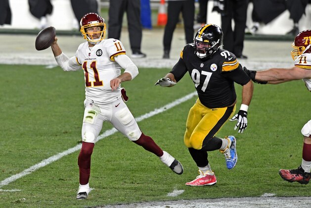 Washington Football Team quarterback Alex Smith (11) gets off a pass under pressure from Pittsburgh Steelers defensive end Cameron Heyward (97) during the first half of an NFL football game in Pittsburgh, Monday, Dec. 7, 2020. (AP Photo/Barry Reeger)
