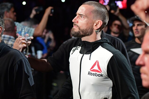 CM Punk walks to the octagon before a welterweight bout at UFC 203 on Saturday, Sept. 10, 2016, in Cleveland. (AP Photo/David Dermer)