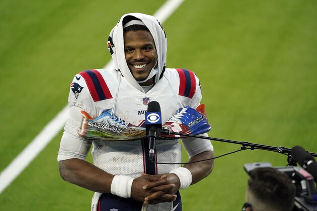 New England Patriots quarterback Cam Newton smiles as he conducts an interview at the end of an NFL football game against the Los Angeles Chargers Sunday, Dec. 6, 2020, in Inglewood, Calif. (AP Photo/Ashley Landis)