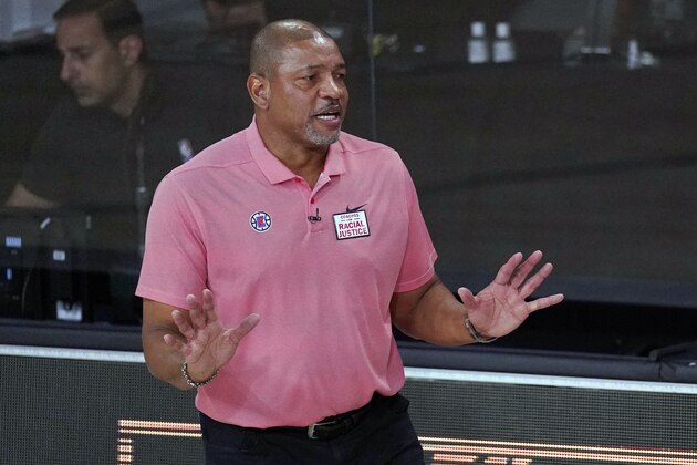 FILE - In this Sept. 15, 2020, file photo, Los Angeles Clippers head coach Doc Rivers questions a call during the first half of an NBA conference semifinal playoff basketball game against the Denver Nuggets in Lake Buena Vista, Fla. Rivers is now head coach of the Philadelphia 76ers. The first preseason camps of the coronavirus era are formally open, with teams limited for now to individual sessions with one coach and one player at one basket, all of this starting to happen as the pandemic continues raging and more and more Americans are testing positive. “I’m very concerned if we can pull this off,” Philadelphia coach Doc Rivers said. (AP Photo/Mark J. Terrill, File) FILE - In this Sept. 15, 2020, file photo, Los Angeles Clippers head coach Doc Rivers questions a call during the first half of an NBA conference semifinal playoff basketball game against the Denver Nuggets in Lake Buena Vista, Fla. Rivers is now head coach of the Philadelphia 76ers. The first preseason camps of the coronavirus era are formally open, with teams limited for now to individual sessions with one coach and one player at one basket, all of this starting to happen as the pandemic continues raging and more and more Americans are testing positive. “I’m very concerned if we can pull this off,” Philadelphia coach Doc Rivers said. (AP Photo/Mark J. Terrill, File)