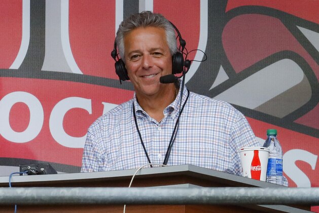 FILE - In this Sept. 25, 2019, file photo, Cincinnati Reds broadcaster Thom Brennaman sits in a special outside booth before the Reds' baseball game against the Milwaukee Brewers in Cincinnati. The Reds say Brennaman has resigned following his use of an anti-gay slur on air in August. (AP Photo/John Minchillo, File)