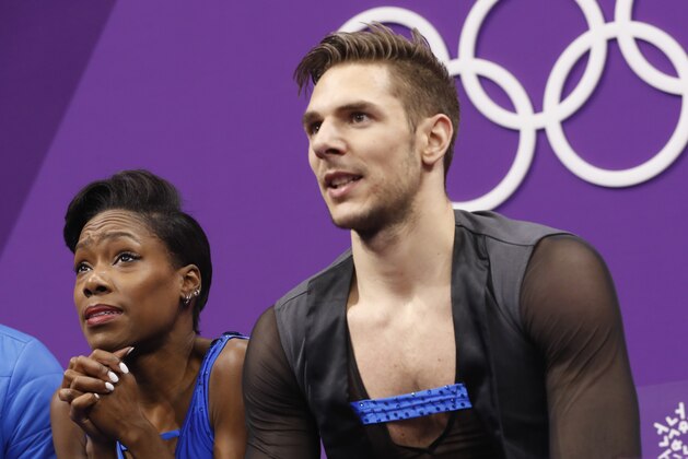 Vanessa James and Morgan Cipres of France react to their scores following their performance in the pair figure skating short program in the Gangneung Ice Arena at the 2018 Winter Olympics in Gangneung, South Korea, Wednesday, Feb. 14, 2018. (AP Photo/Bernat Armangue)