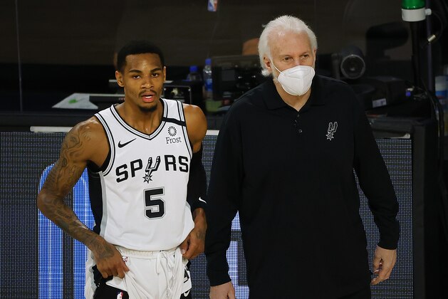 San Antonio Spurs head coach Gregg Popovich, right, talks with Dejounte Murray (5) during the first quarter of an NBA basketball game against the Utah Jazz, Thursday, Aug. 13, 2020, in Lake Buena Vista, Fla. (Kevin C. Cox/Pool Photo via AP)