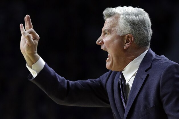 FILE - In this Monday, Jan. 29, 2018, file photo, Kansas State head coach Bruce Weber signals his team during the first half of an NCAA college basketball game against Kansas in Manhattan, Kan. Kansas State plays at West Virginia Saturday in the Big 12’s biggest game of the weekend. After losing four times in five games, the Mountaineers were struggling to keep pace with Kansas, and K-State got rolled by the Jayhawks on Monday. (AP Photo/Orlin Wagner, File)