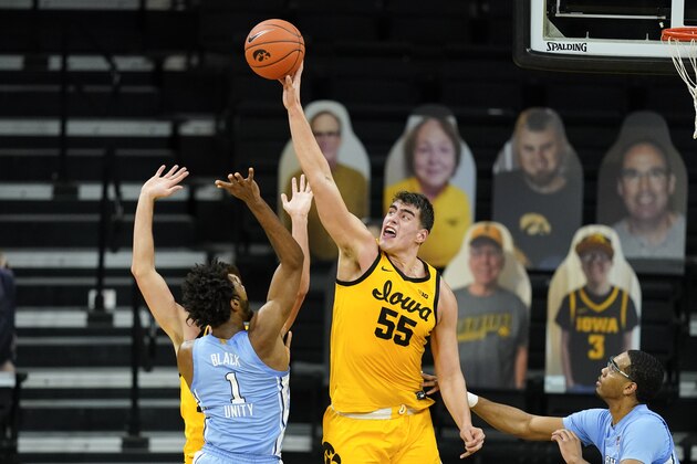 Iowa center Luka Garza (55) blocks a shot by North Carolina guard Leaky Black (1) during the second half of an NCAA college basketball game, Tuesday, Dec. 8, 2020, in Iowa City, Iowa. Iowa won 93-80. (AP Photo/Charlie Neibergall)