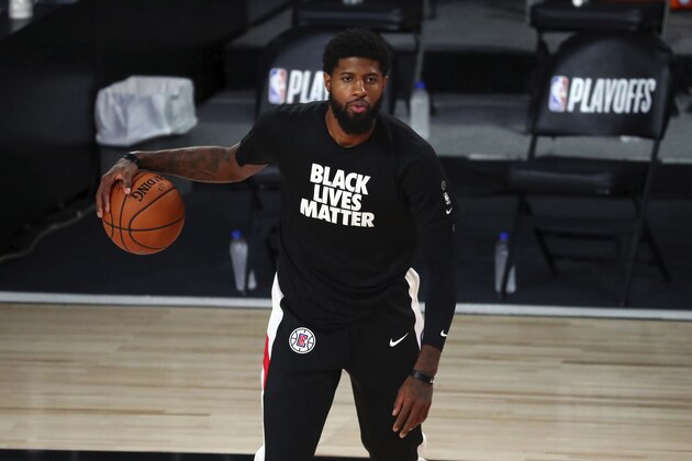 Los Angeles Clippers guard Paul George warms up for Game 5 of an NBA basketball first-round playoff series against the Dallas Mavericks, Tuesday, Aug. 25, 2020, in Lake Buena Vista, Fla. (Kim Klement/Pool Photo via AP)