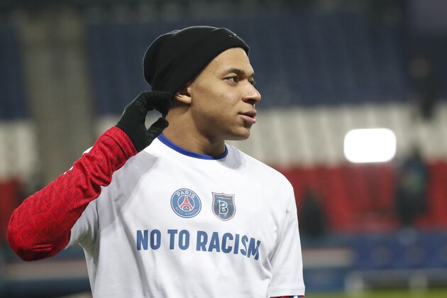 PSG's Kylian Mbappe warms up before the Champions League group H soccer match between Paris Saint Germain and Istanbul Basaksehir at the Parc des Princes stadium in Paris, France, Wednesday, Dec. 9, 2020. The match is resuming on Wednesday with a new refereeing team after players from Paris Saint-Germain and Istanbul Basaksehir left the field on Tuesday evening and didn't return when the fourth official — Sebastian Coltescu of Romania — was accused of using a racial term to identify Basaksehir assistant coach Pierre Webo before sending him off for his conduct on the sidelines. (AP Photo/Francois Mori)