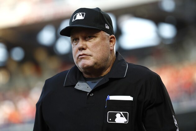 Umpire Brian O'Nora walks on the filed during a baseball game between the Los Angeles Dodgers and the Washington Nationals, Friday, July 26, 2019, in Washington. (AP Photo/Patrick Semansky)