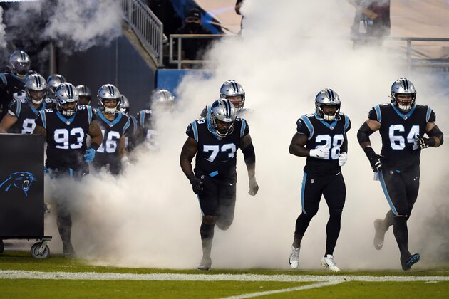 Carolina Panthers offensive guard Chris Reed (64), running back Mike Davis (28) and offensive tackle Juwann Bushell-Beatty (73) take the field against the Atlanta Falcons during an NFL football game in Charlotte, N.C., Thursday, Oct. 29, 2020. (AP Photo/Gerry Broome)