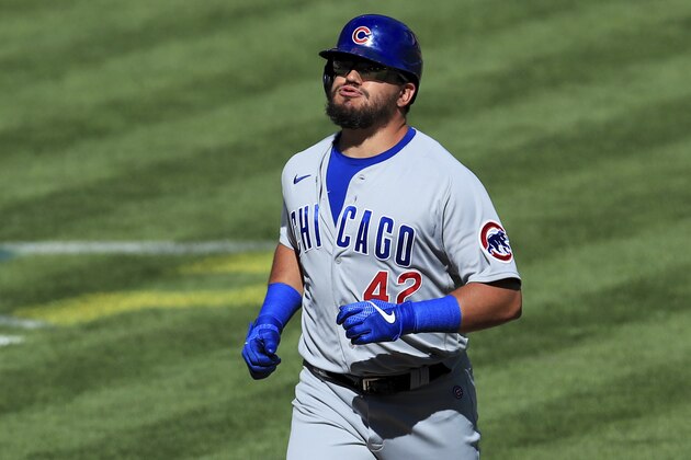 Chicago Cubs' Kyle Schwarber reacts after hitting a grand slam in the ninth inning during a baseball game against the Cincinnati Reds in Cincinnati, Sunday, Aug. 30, 2020. The Cubs won 10-1. (AP Photo/Aaron Doster)