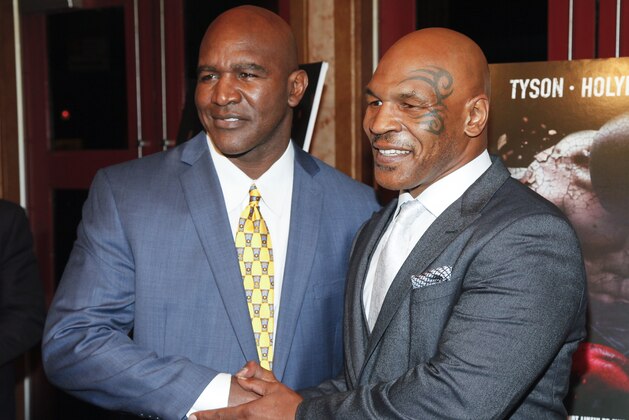 Evander Holyfield, left, and Mike Tyson, attend a special screening of