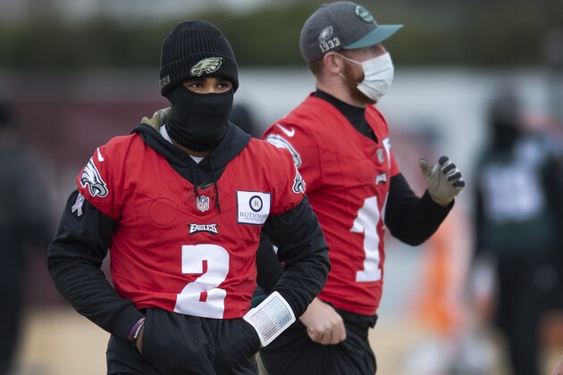 Philadelphia Eagles quarterbacks Jalen Hurts, left and Carson Wentz participate in a drill during practice at the NFL football team's training facility, Wednesday, Dec. 9, 2020, in Philadelphia. (Jose F. Moreno/The Philadelphia Inquirer via AP, Pool)