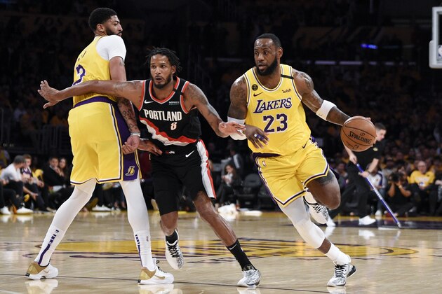 Los Angeles Lakers forward LeBron James, right, handles the ball while Anthony Davis, left, sets a screen on Portland Trail Blazers forward Trevor Ariza during the second half of an NBA basketball game in Los Angeles, Friday, Jan. 31, 2020. (AP Photo/Kelvin Kuo) Los Angeles Lakers forward LeBron James, right, handles the ball while Anthony Davis, left, sets a screen on Portland Trail Blazers forward Trevor Ariza during the second half of an NBA basketball game in Los Angeles, Friday, Jan. 31, 2020. (AP Photo/Kelvin Kuo)