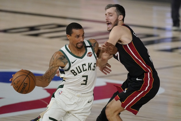 Milwaukee Bucks' George Hill (3) drives around Miami Heat's Goran Dragic, right, in the second half of an NBA conference semifinal playoff basketball game Tuesday, Sept. 8, 2020 in Lake Buena Vista, Fla. (AP Photo/Mark J. Terrill)
