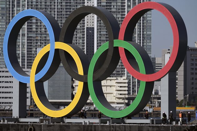 The Olympic Symbol is reinstalled after it was taken down for maintenance ahead of the postponed Tokyo 2020 Olympics in the Odaiba section Tuesday, Dec. 1, 2020, in Tokyo. The five Olympic rings are back in Tokyo Bay. (AP Photo/Eugene Hoshiko)