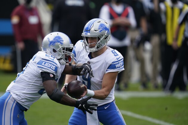Detroit Lions quarterback Matthew Stafford (9) hands off to running back Adrian Peterson (28) during the first half of an NFL football game against the Carolina Panthers Sunday, Nov. 22, 2020, in Charlotte, N.C. (AP Photo/Gerry Broome) Detroit Lions quarterback Matthew Stafford (9) hands off to running back Adrian Peterson (28) during the first half of an NFL football game against the Carolina Panthers Sunday, Nov. 22, 2020, in Charlotte, N.C. (AP Photo/Gerry Broome)