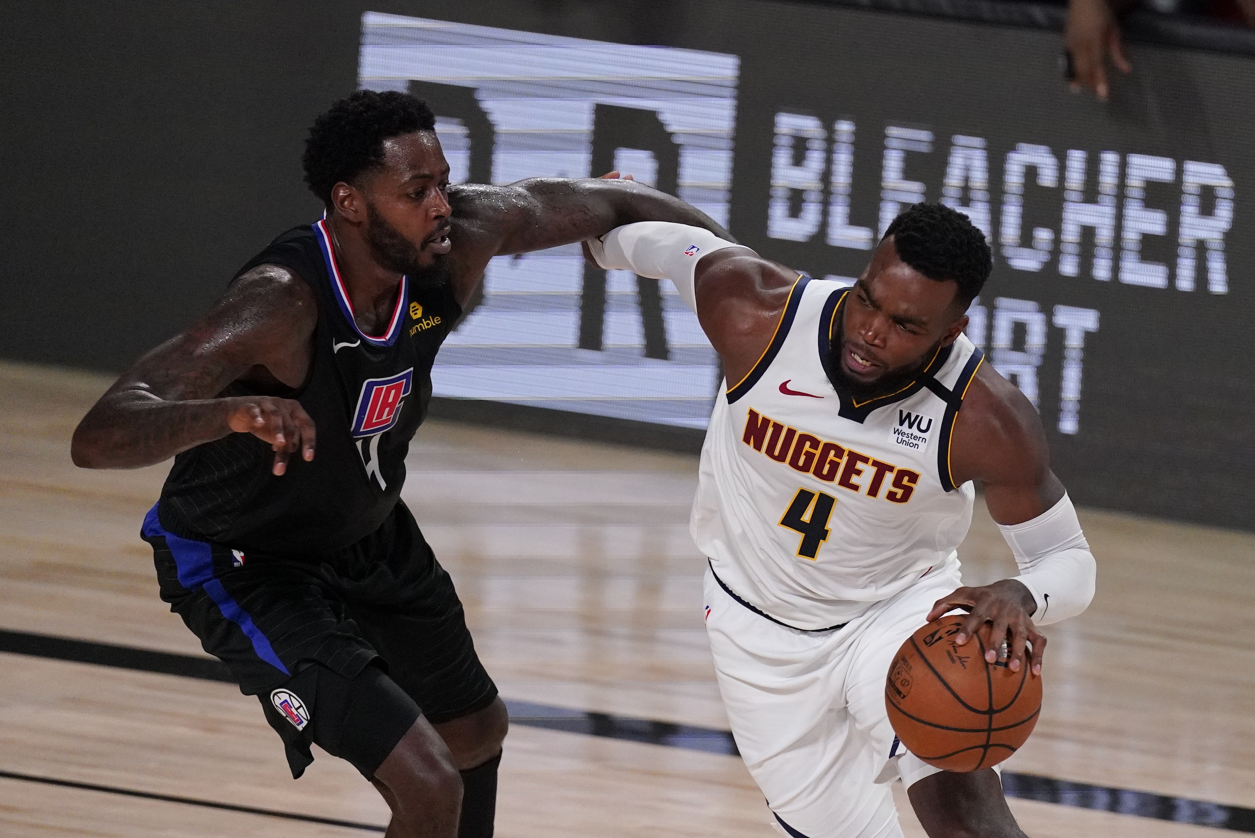 Denver Nuggets' Paul Millsap drives around Los Angeles Clippers' JaMychal Green, left, during the second half of an NBA conference semifinal playoff basketball game Saturday, Sept. 5, 2020, in Lake Buena Vista, Fla. (AP Photo/Mark J. Terrill) Denver Nuggets' Paul Millsap drives around Los Angeles Clippers' JaMychal Green, left, during the second half of an NBA conference semifinal playoff basketball game Saturday, Sept. 5, 2020, in Lake Buena Vista, Fla. (AP Photo/Mark J. Terrill)