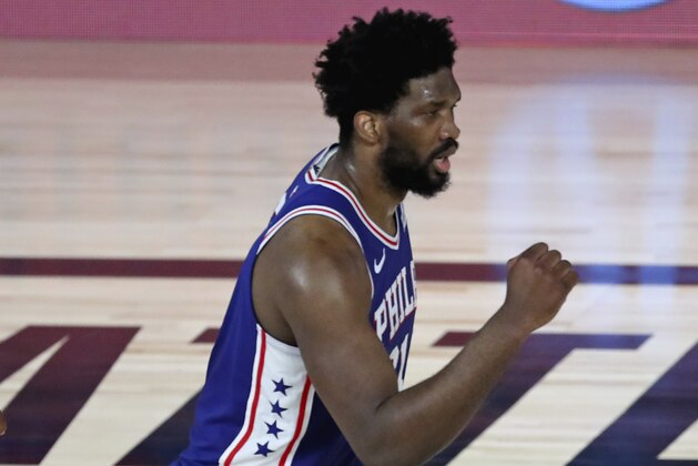 Philadelphia 76ers center Joel Embiid (21) reacts after making a basket and being fouled on the shot during the first half of Game 3 of an NBA basketball first-round playoff series against the Boston Celtics, Friday, Aug. 21, 2020, in Lake Buena Vista, Fla. (Kim Klement/Pool Photo via AP)