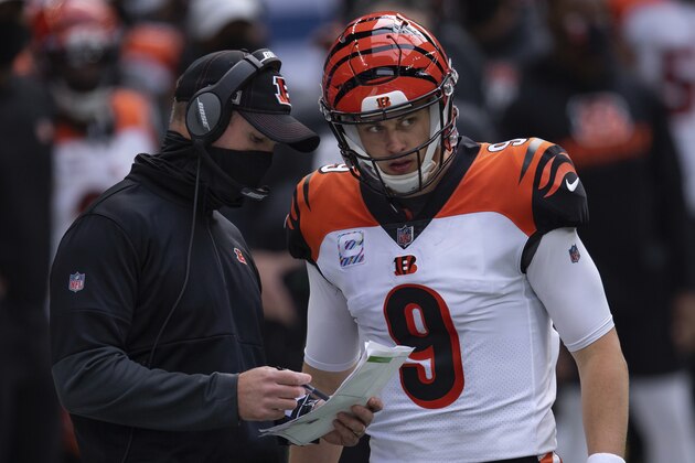 Cincinnati Bengals quarterback Joe Burrow (9) and Cincinnati Bengals head coach Zac Taylor talk on the field during an NFL football game between the Indianapolis Colts and Cincinnati Bengals, Sunday, Oct. 18, 2020, in Indianapolis. (AP Photo/Zach Bolinger)