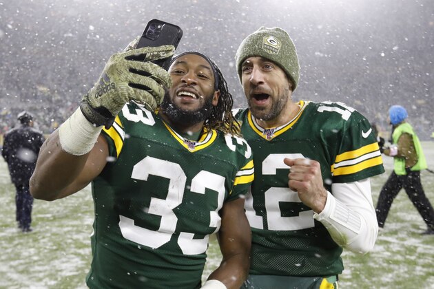 Green Bay Packers' Aaron Jones and Aaron Rodgers take a selfie after an NFL football game against the Carolina Panthers Sunday, Nov. 10, 2019, in Green Bay, Wis. The Packers won 24-16. (AP Photo/Mike Roemer)