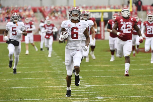 Alabama punt returner DeVonta Smith (6) returns a punt for a touchdown against Arkansas during the first half of an NCAA college football game Saturday, Dec. 12, 2020, in Fayetteville, Ark. (AP Photo/Michael Woods)