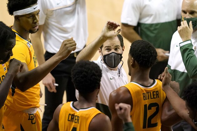 Baylor coach Scott Drew, center, leads a huddle during in a timeout in the second half of the team's NCAA college basketball game against Stephen F. Austin in Waco, Texas, Wednesday, Dec. 9, 2020. (AP Photo/Tony Gutierrez)