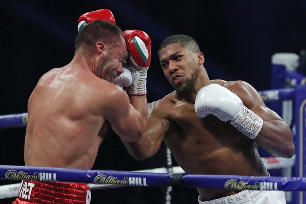 World Heavyweight boxing champion Britain's Anthony Joshua punches challenger Bulgaria's Kubrat Pulev during their Heavyweight title fight at Wembley Arena in London Saturday, Dec. 12, 2020. (Andrew Couldridge/Pool via AP)