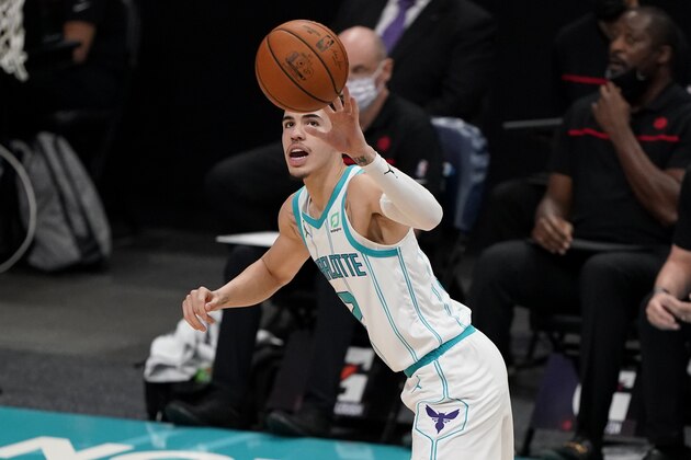 Charlotte Hornets guard LaMelo Ball passes the ball against the Toronto Raptors during the first half of an NBA preseason basketball game in Charlotte, N.C., on Saturday, Dec. 12, 2020. (AP Photo/Chris Carlson)