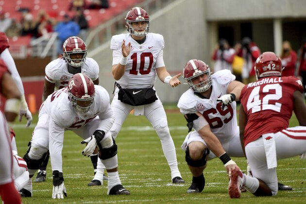 Alabama quarterback Mac Jones (10) gets ready to run a play against Arkansas during an NCAA college football game Saturday, Dec. 12, 2020, in Fayetteville, Ark. (AP Photo/Michael Woods) Alabama quarterback Mac Jones (10) gets ready to run a play against Arkansas during an NCAA college football game Saturday, Dec. 12, 2020, in Fayetteville, Ark. (AP Photo/Michael Woods)
