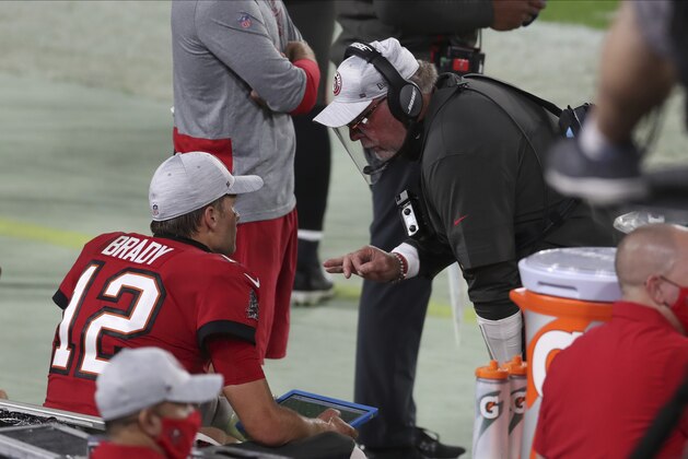 Tampa Bay Buccaneers head coach Bruce Arians talks to quarterback Tom Brady (12) during the second half of an NFL football game against the Kansas City Chiefs Sunday, Nov. 29, 2020, in Tampa, Fla. (AP Photo/Mark LoMoglio)