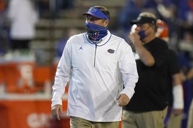 Florida head coach Dan Mullen watches players warm up before an NCAA college football game against LSU, Saturday, Dec. 12, 2020, in Gainesville, Fla. (AP Photo/John Raoux)