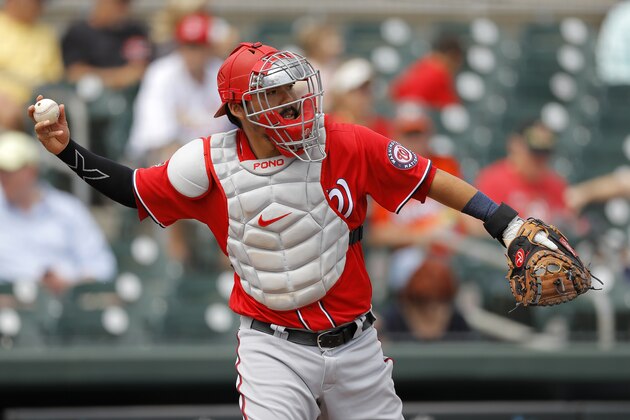Washington Nationals catcher Kurt Suzuki warms up during the first inning of a spring training baseball game against the Miami Marlins, Tuesday, March 10, 2020, in Jupiter, Fla. (AP Photo/Julio Cortez)