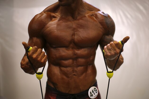 A competitor warms up in the backstage area of the Arnold Classic Europe bodybuilding event in Barcelona, Spain, Saturday, Sept. 24, 2016. Arnold Classic Europe event runs from Sept. 23 till 25. (AP Photo/Manu Fernandez)