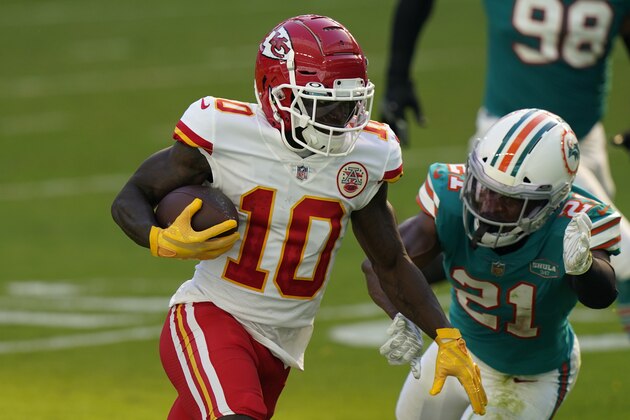 Kansas City Chiefs wide receiver Tyreek Hill (10) runs for a touchdown as Miami Dolphins free safety Eric Rowe (21) attempt to tackle, during the first half of an NFL football game, Sunday, Dec. 13, 2020, in Miami Gardens, Fla. (AP Photo/Lynne Sladky)