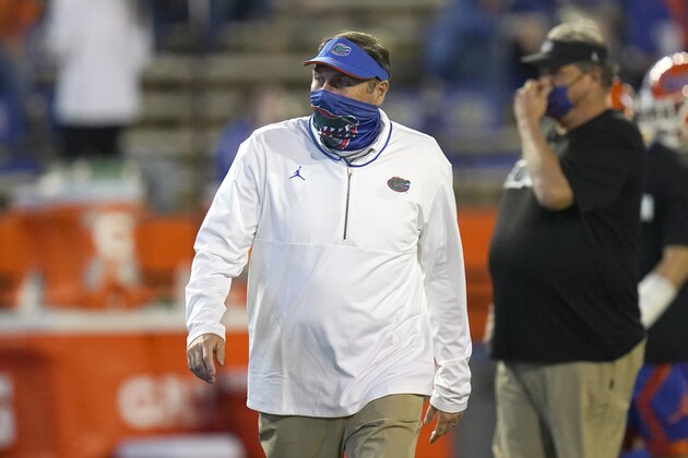 Florida head coach Dan Mullen watches players warm up before an NCAA college football game against LSU, Saturday, Dec. 12, 2020, in Gainesville, Fla. (AP Photo/John Raoux) Florida head coach Dan Mullen watches players warm up before an NCAA college football game against LSU, Saturday, Dec. 12, 2020, in Gainesville, Fla. (AP Photo/John Raoux)