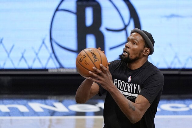 Brooklyn Nets center Kevin Durant, who was out the entire last season with an achilles injury, warms up before a preseason NBA basketball game against the Washington Wizards, Sunday, Dec. 13, 2020, in New York. (AP Photo/Kathy Willens)