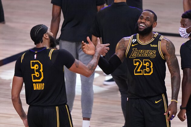 Los Angeles Lakers' LeBron James (23) celebrates with teammate Anthony Davis (3) after an NBA conference final playoff basketball game against the Denver Nuggets Sunday, Sept. 20, 2020, in Lake Buena Vista, Fla. The Lakers won 105-103. (AP Photo/Mark J. Terrill) Los Angeles Lakers' LeBron James (23) celebrates with teammate Anthony Davis (3) after an NBA conference final playoff basketball game against the Denver Nuggets Sunday, Sept. 20, 2020, in Lake Buena Vista, Fla. The Lakers won 105-103. (AP Photo/Mark J. Terrill)