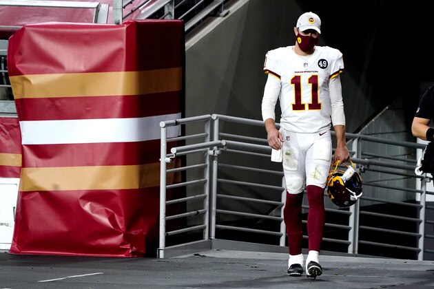 Washington Football Team quarterback Alex Smith (11) walks to the field for the start of the second half of an NFL football game against the San Francisco 49ers, Sunday, Dec. 13, 2020, in Glendale, Ariz. Washington Football Team quarterback Dwayne Haskins replaced Smith for the start of the second half. (AP Photo/Rick Scuteri)