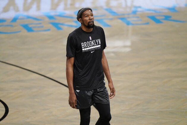 Brooklyn Nets forward Kevin Durant (7) rests during warmups before the start of a preseason NBA basketball game against the Washington Wizards, Sunday, Dec. 13, 2020, in New York. (AP Photo/Kathy Willens)