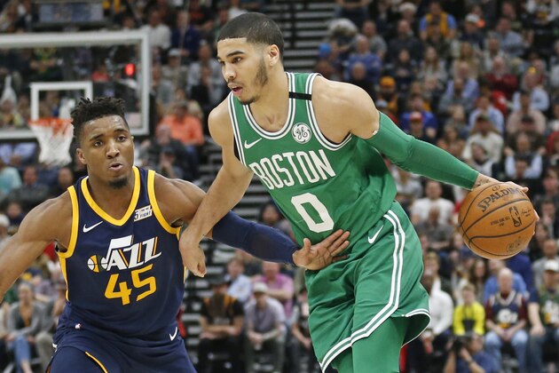 Utah Jazz guard Donovan Mitchell (45) guards Boston Celtics forward Jayson Tatum (0) as he drives in the second half during an NBA basketball game Wednesday, March 28, 2018, in Salt Lake City. (AP Photo/Rick Bowmer)