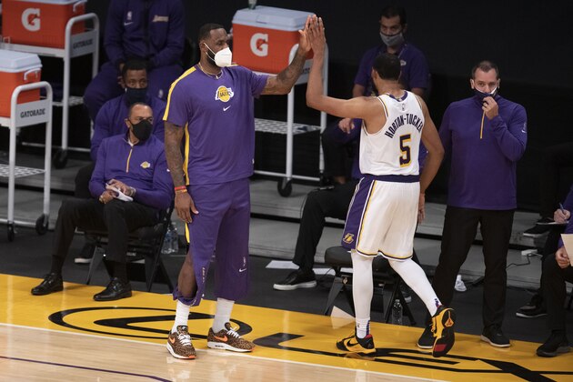 Los Angeles Lakers forward LeBron James, left, greets guard Talen Horton-Tucker, who was heading to the bench during the second half of the team's NBA preseason basketball game against the Los Angeles Clippers in Los Angeles, Friday, Dec. 11, 2020. (AP Photo/Kyusung Gong)