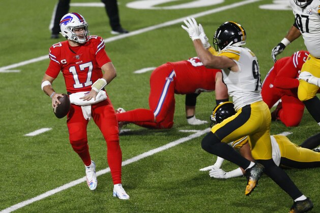 Buffalo Bills quarterback Josh Allen (17) gets off a pass under pressure by Pittsburgh Steelers outside linebacker T.J. Watt (90) during the first half of an NFL football game in Orchard Park, N.Y., Sunday, Dec. 13, 2020. (AP Photo/Jeffrey T. Barnes )