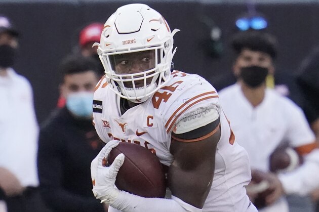 Texas' Joseph Ossai carries during an NCAA college football game against Oklahoma State, in Stillwater, Okla., Saturday, Oct. 31, 2020. (AP Photo/Sue Ogrocki)