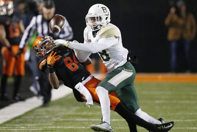 Baylor safety Chance Waz (18) breaks up a pass intended for Oklahoma State wide receiver Jalen McCleskey (84) during the third quarter of an NCAA college football game in Stillwater, Okla., Saturday, Nov. 21, 2015. Baylor won 45-35. (AP Photo/Sue Ogrocki)