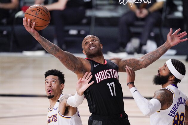 Houston Rockets' P.J. Tucker (17) grabs a rebound between Los Angeles Lakers' Danny Green, left, and Markieff Morris during the first half of an NBA conference semifinal playoff basketball game Saturday, Sept. 12, 2020, in Lake Buena Vista, Fla. (AP Photo/Mark J. Terrill)