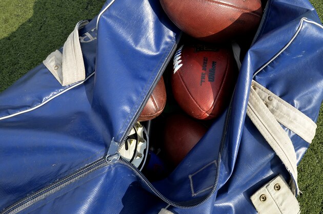 A bag of footballs sits on the field prior to the Pro Football Hall of Fame exhibition NFL football game between the New York Giants and the Buffalo Bills Sunday, Aug. 3, 2014, in Canton, Ohio. New York won 17-13. (AP Photo/David Richard)