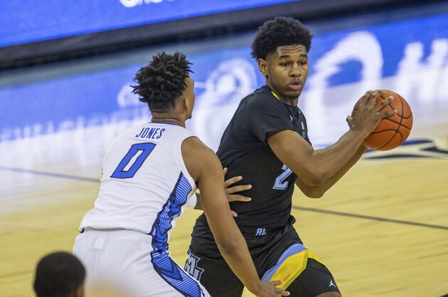 Marquette forward Justin Lewis (2) ready to pass against Creighton guard Antwann Jones (0) in the first half during an NCAA basketball game on Monday, Dec. 14, 2020, in Omaha, Neb. (AP Photo/John Peterson)