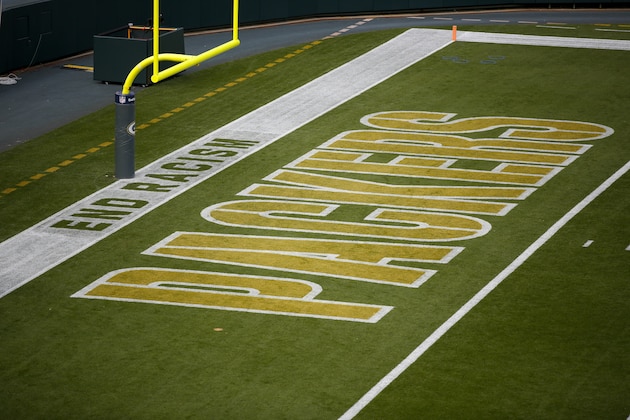 An end racism logo is painted on the field at Lambeau Field before an NFL football game between the Green Bay Packers and the Detroit Lions Sunday, Sept. 20, 2020, in Green Bay, Wis. (AP Photo/Matt Ludtke)